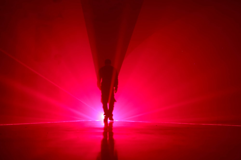 person walking on red tunnel