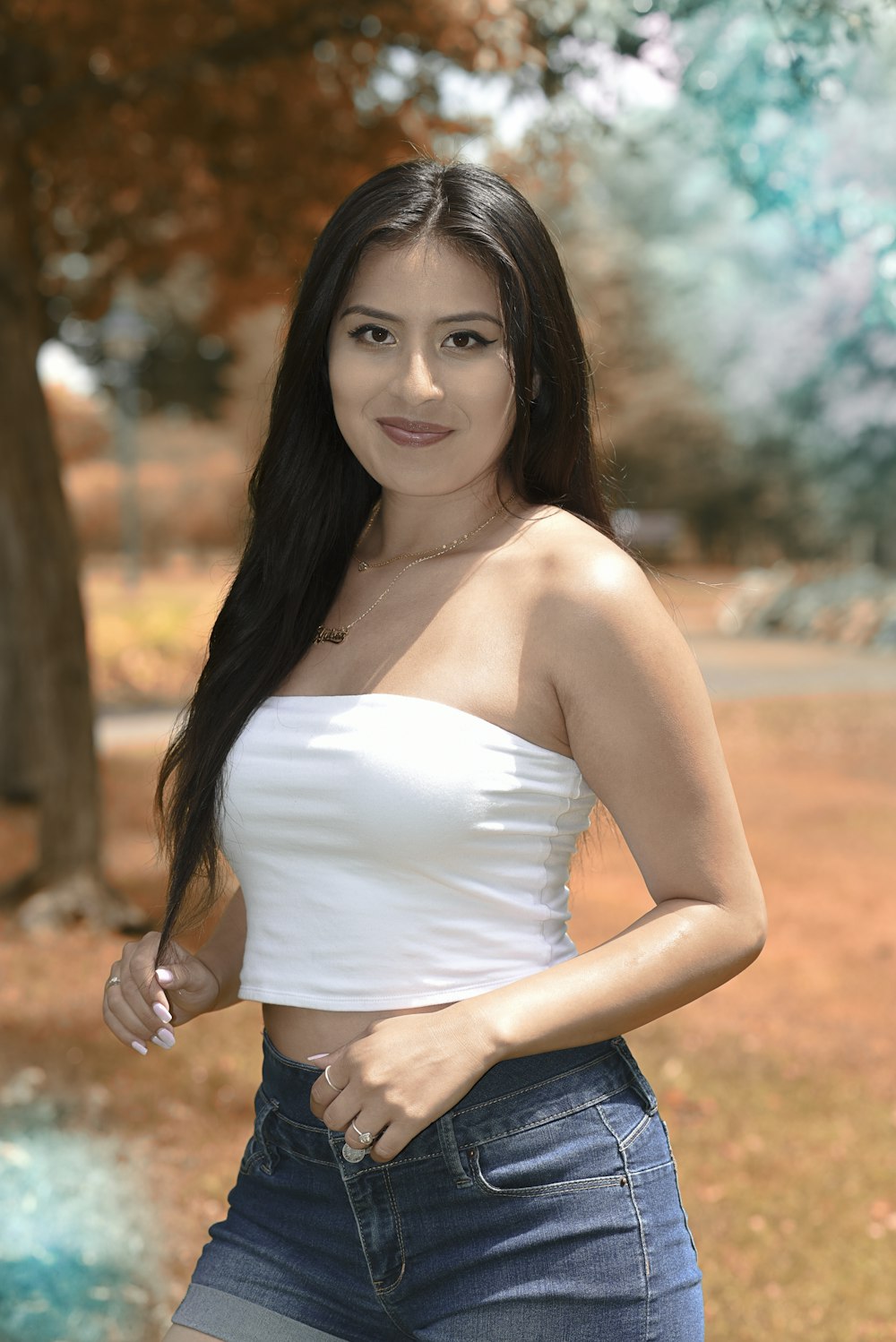 a woman in a white top posing for a picture