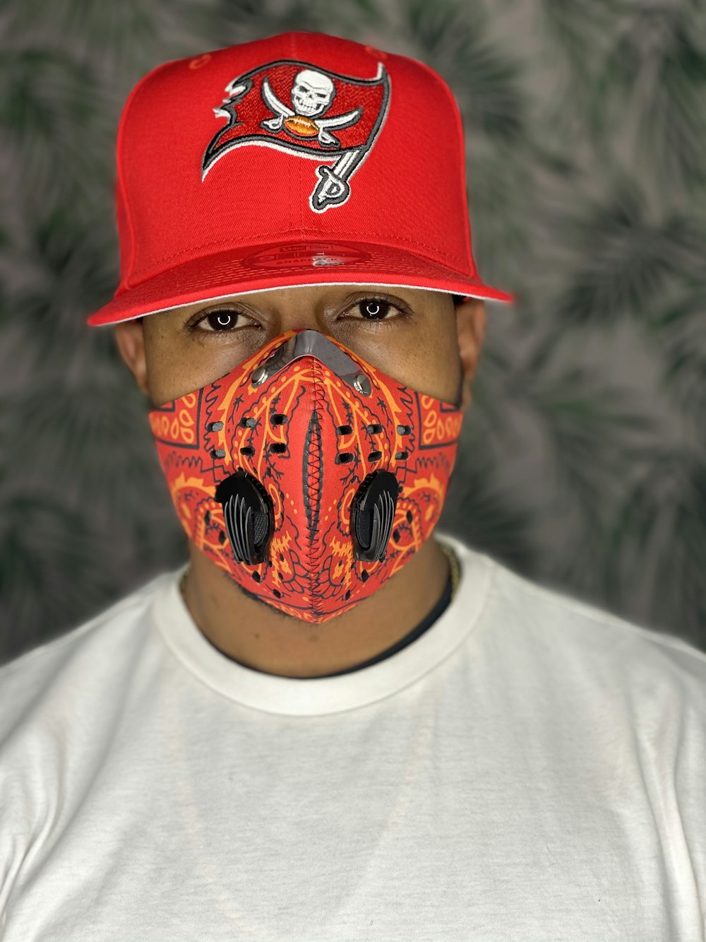 man in white crew neck shirt wearing red and black mask