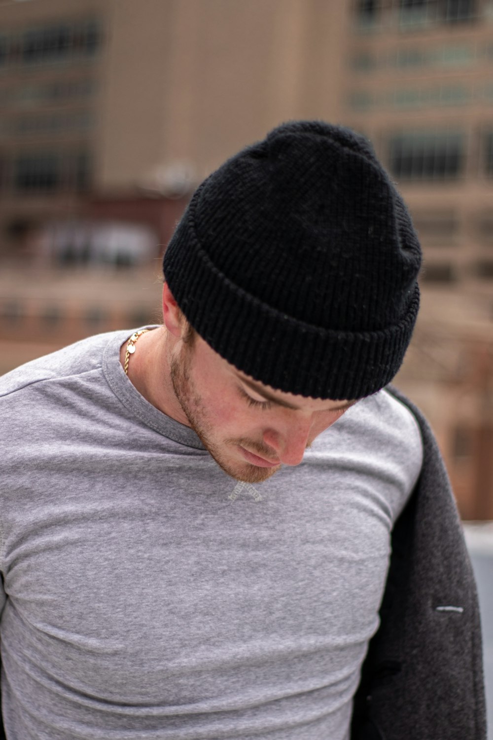 man in gray crew neck shirt wearing black knit cap