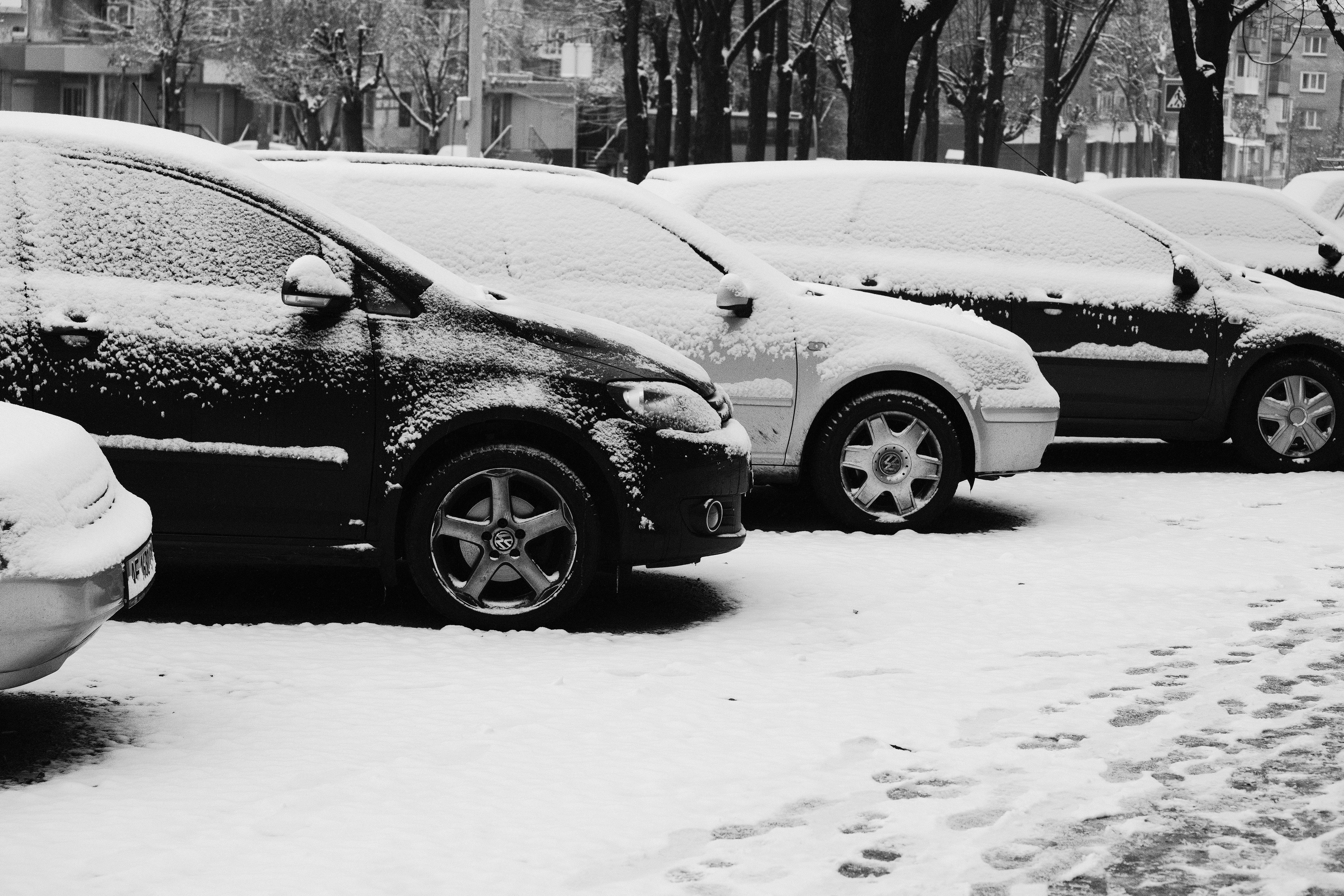 black suv on snow covered ground during daytime