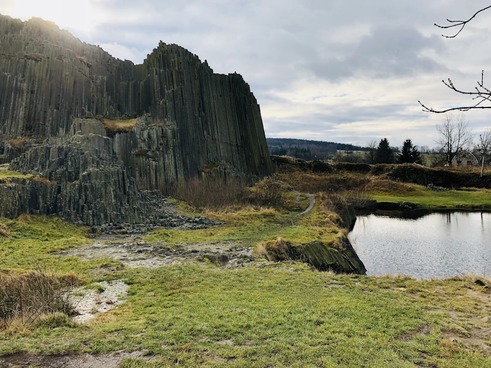 brown rock formation near body of water during daytime