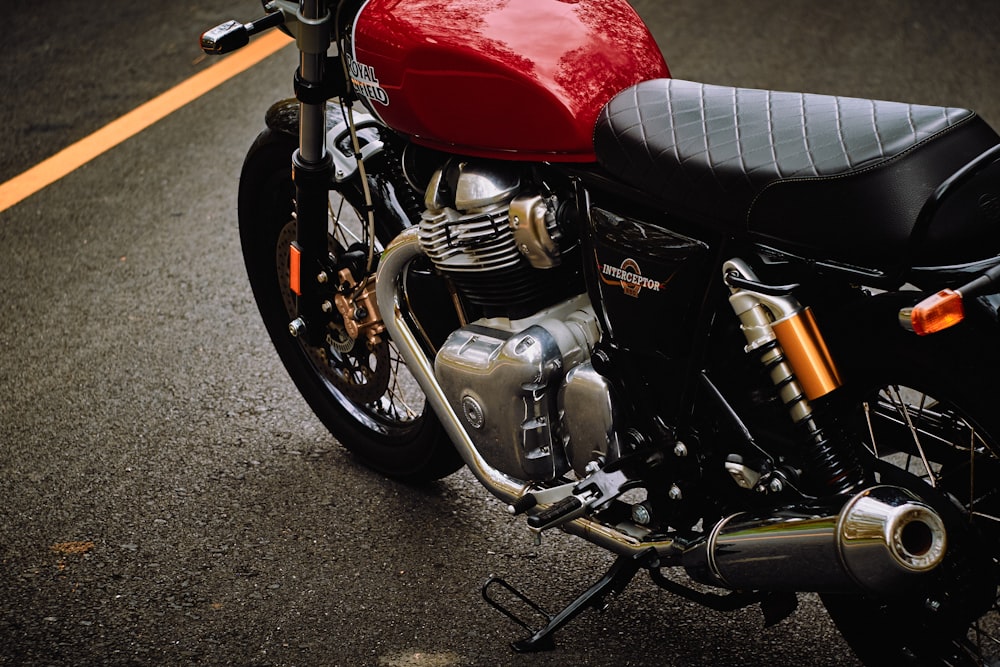 red and black motorcycle on gray asphalt road