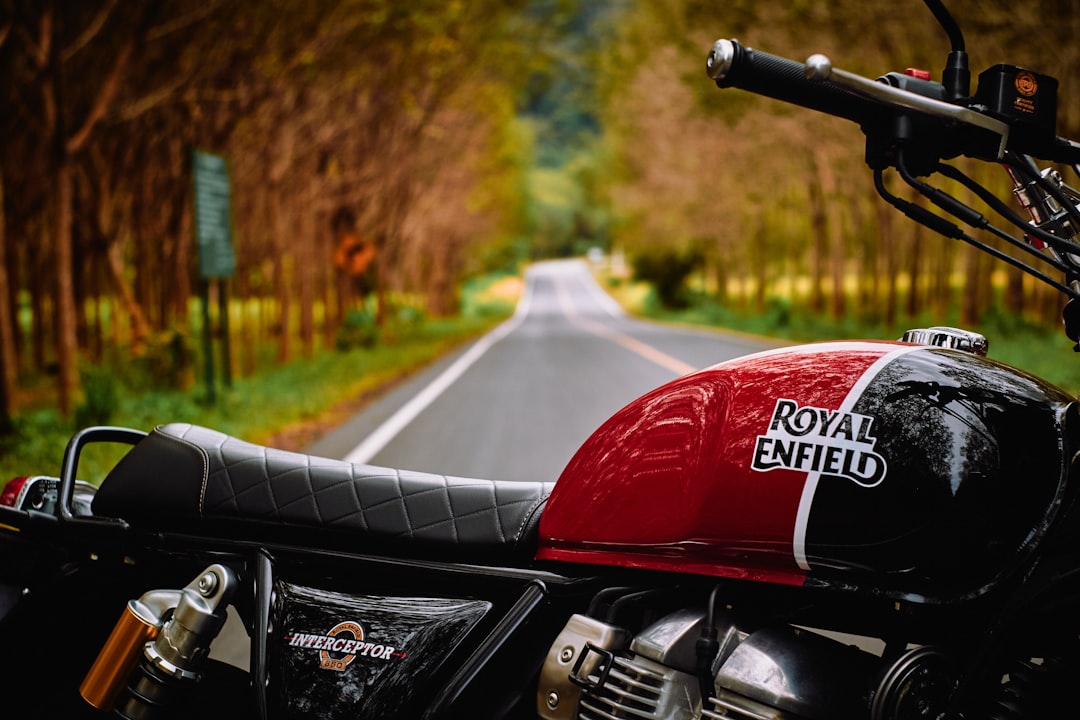 red and black motorcycle parked on the side of the road