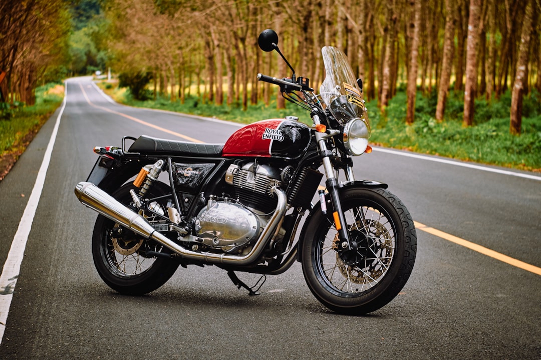 red and black motorcycle on road during daytime