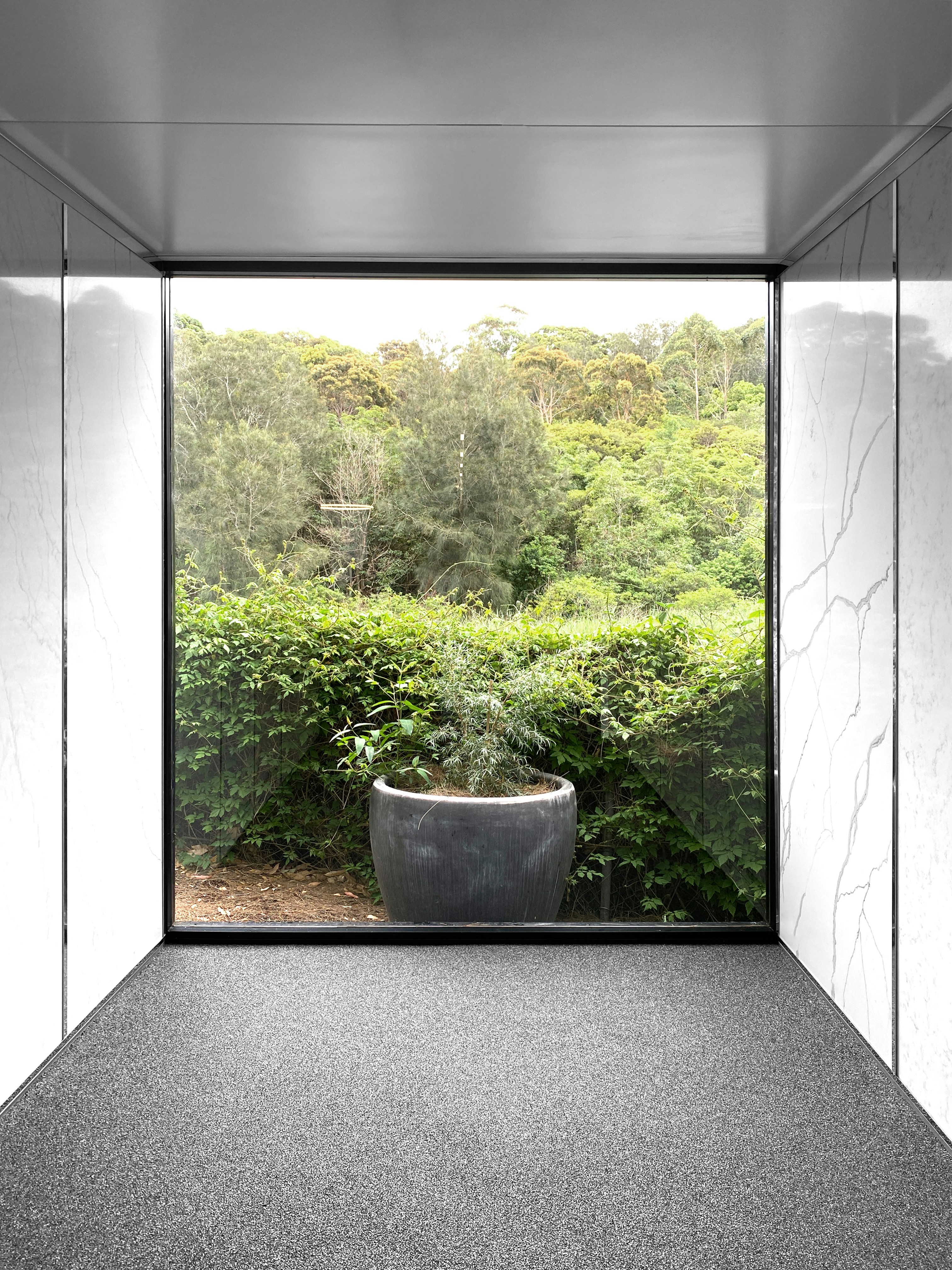 Interior view of large aluminum framed sliding windows with clean sightlines, neutral wall tones