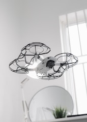 Drones navigating through a restaurant to deliver drinks.