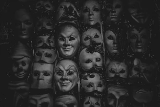 Collection of delicate theatrical props including old masks and tiny swords.