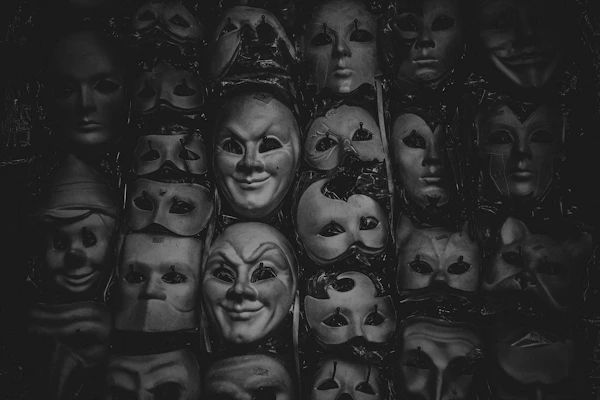 Collection of delicate theatrical props including old masks and tiny swords.