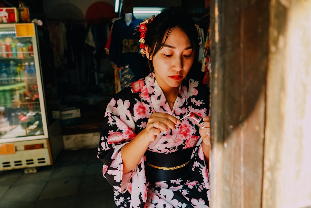 woman in black white and pink floral kimono