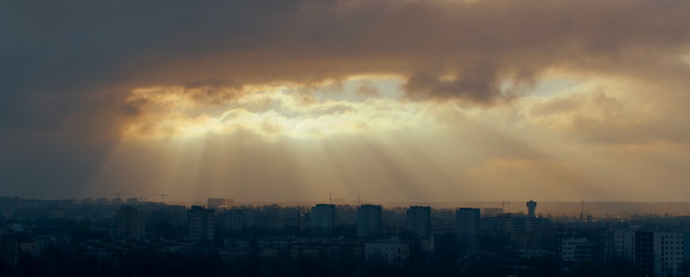 high rise buildings under white clouds during daytime