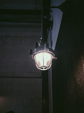 Rustic industrial retro fixture mounted on a brick wall, softly illuminating the space.