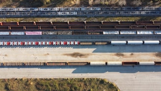 A truck at a rail yard, loading cargo.