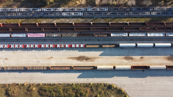 A truck at a rail yard, loading cargo.