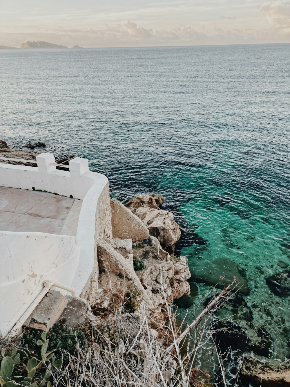 white concrete building near body of water during daytime