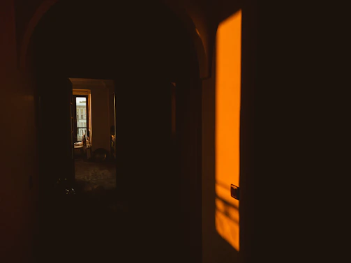 A warm, sunlit room with an open door inviting connection and joy.