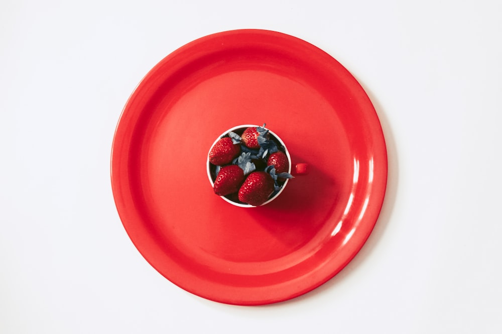 silver and red round ornament on red round plate
