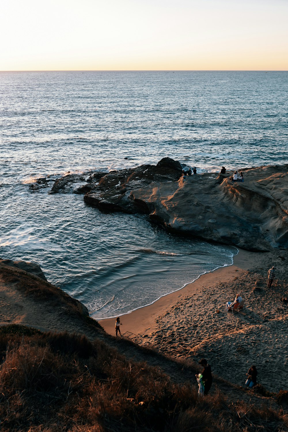 brown rocky shore near body of water during daytime