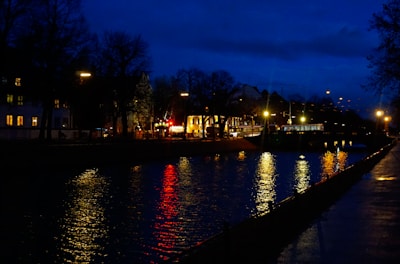 Nighttime scene of twinkling lights along the Riverwalk bridge.