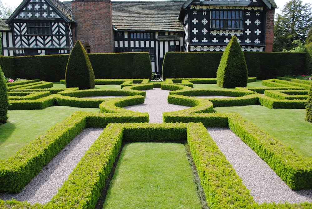 green grass lawn near brown brick house