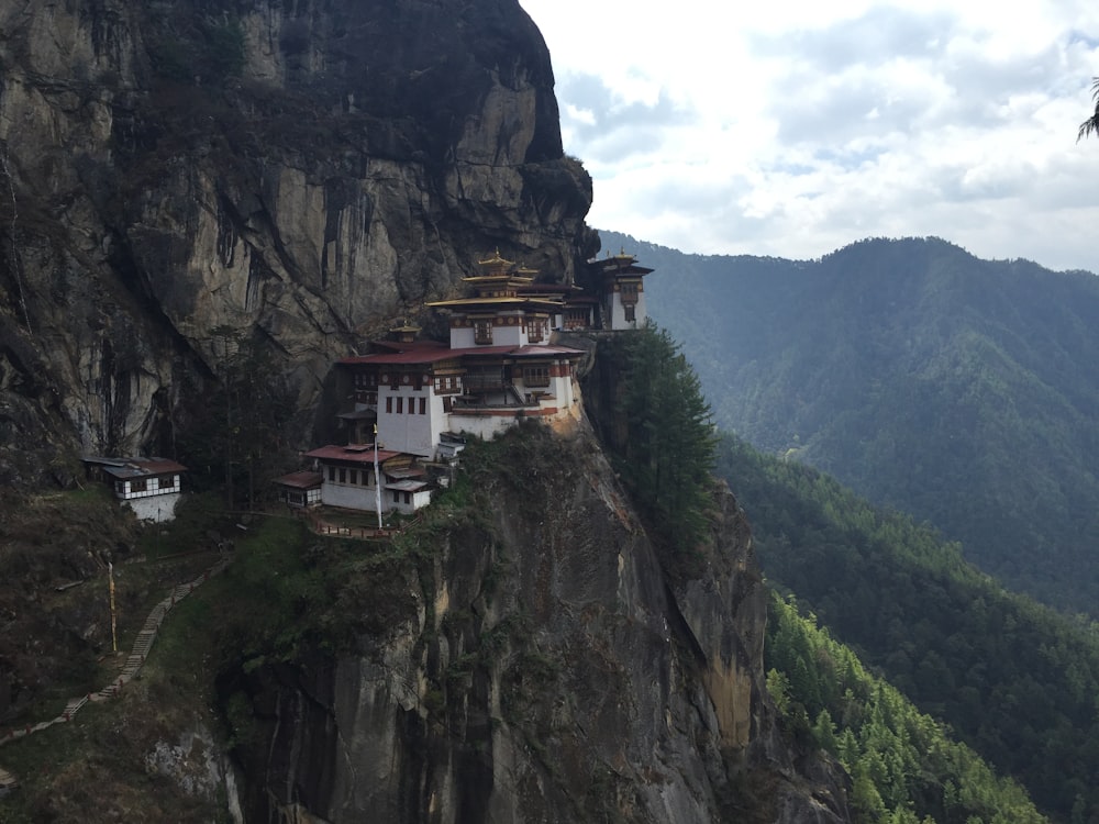 white and brown concrete house on top of mountain during daytime