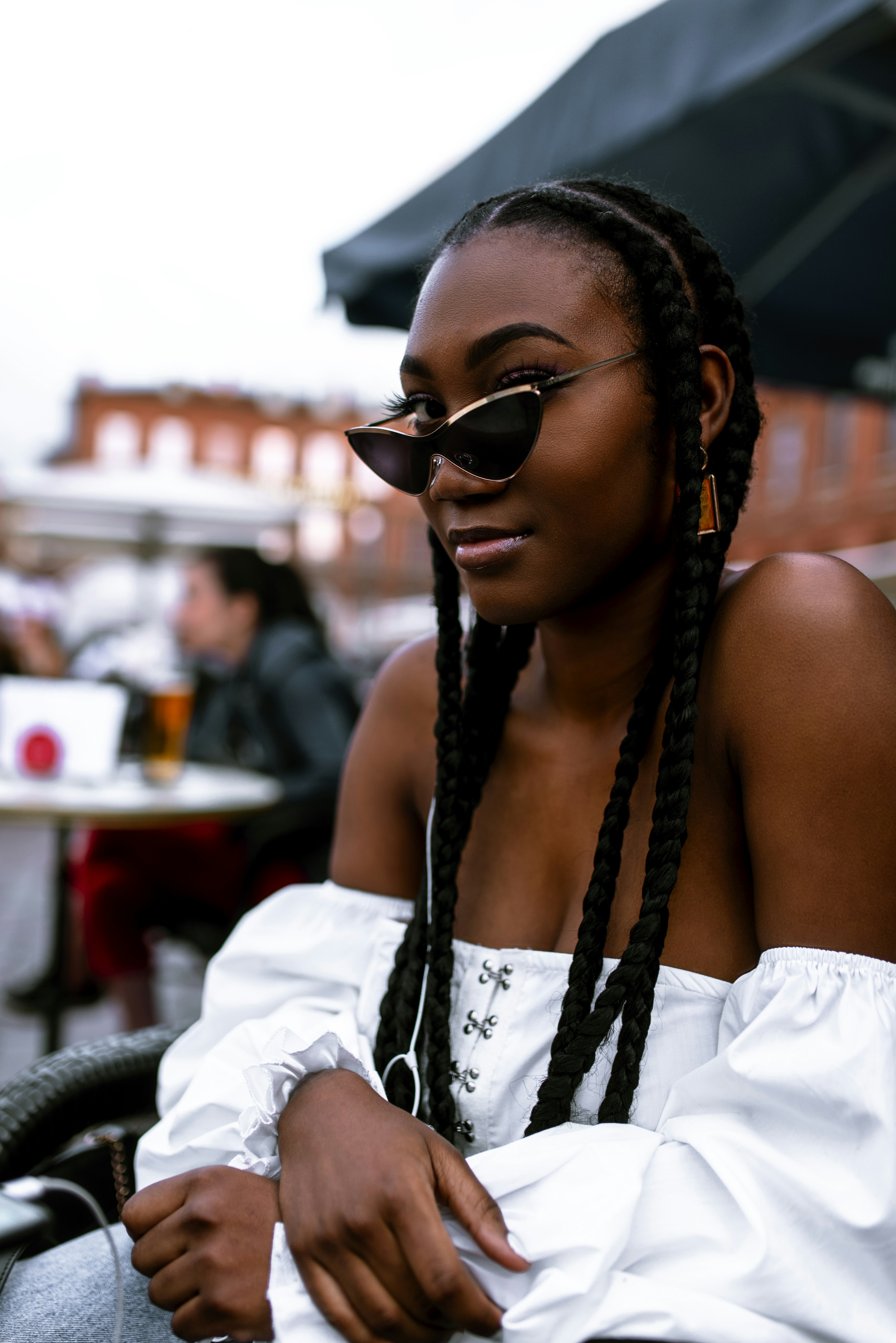 woman-in-white-sleeveless-top-wearing-black-sunglasses