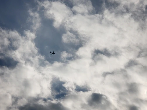 Silhouetted aircraft flying high above the horizon, preparing for the next jump with parachutes visible inside.