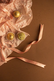 Elegant packaging of delicata cookies with soft beige and gold accents.