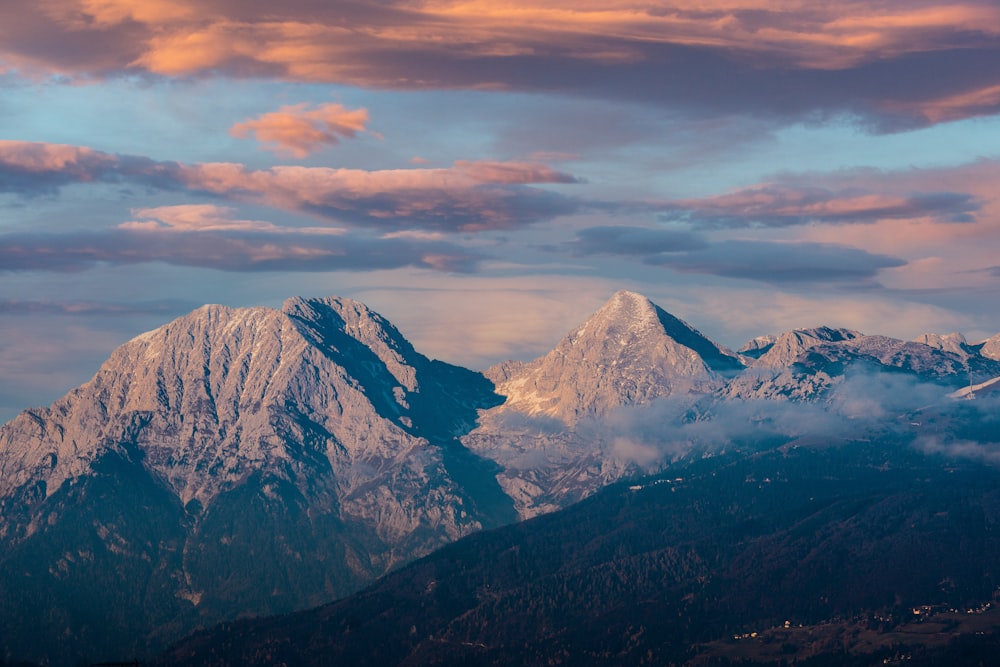 snow covered mountain under cloudy sky during daytime