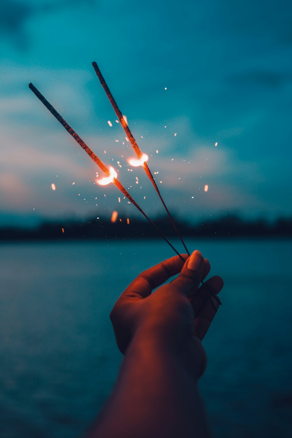 person holding red and white string lights