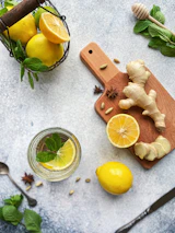 Close-up of vibrant detox ingredients like lemon, ginger, and mint leaves.