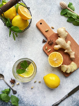 Close-up of vibrant detox ingredients like lemon, ginger, and mint leaves.