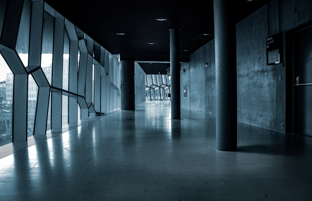 grayscale photo of hallway with light