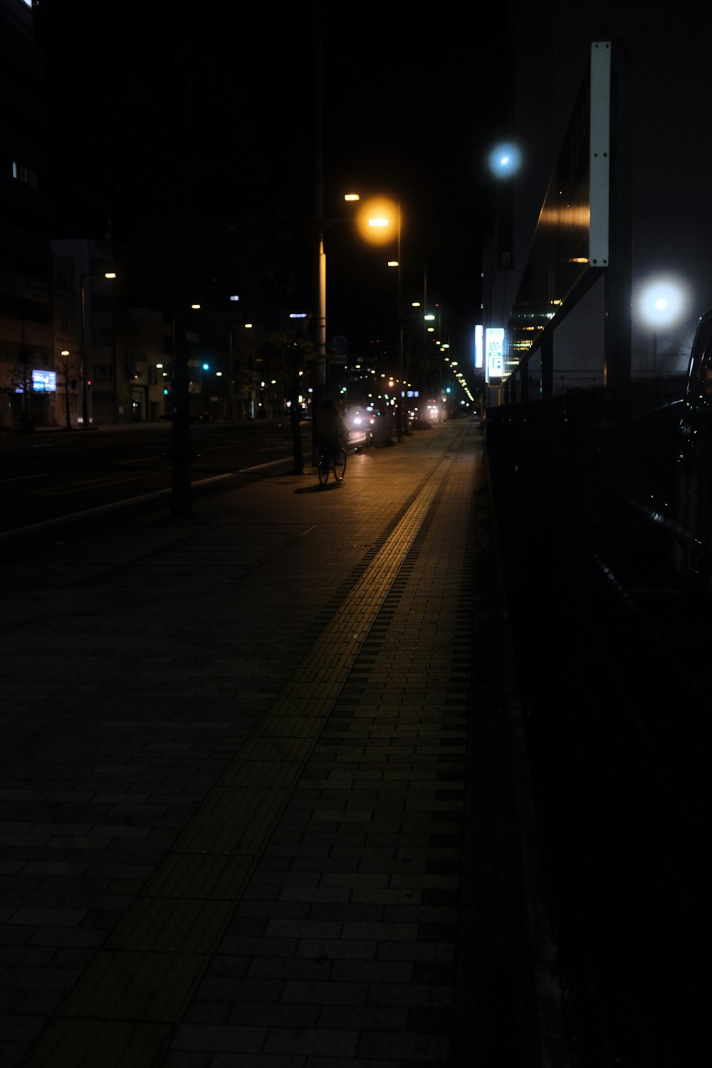 black metal fence near road during night time