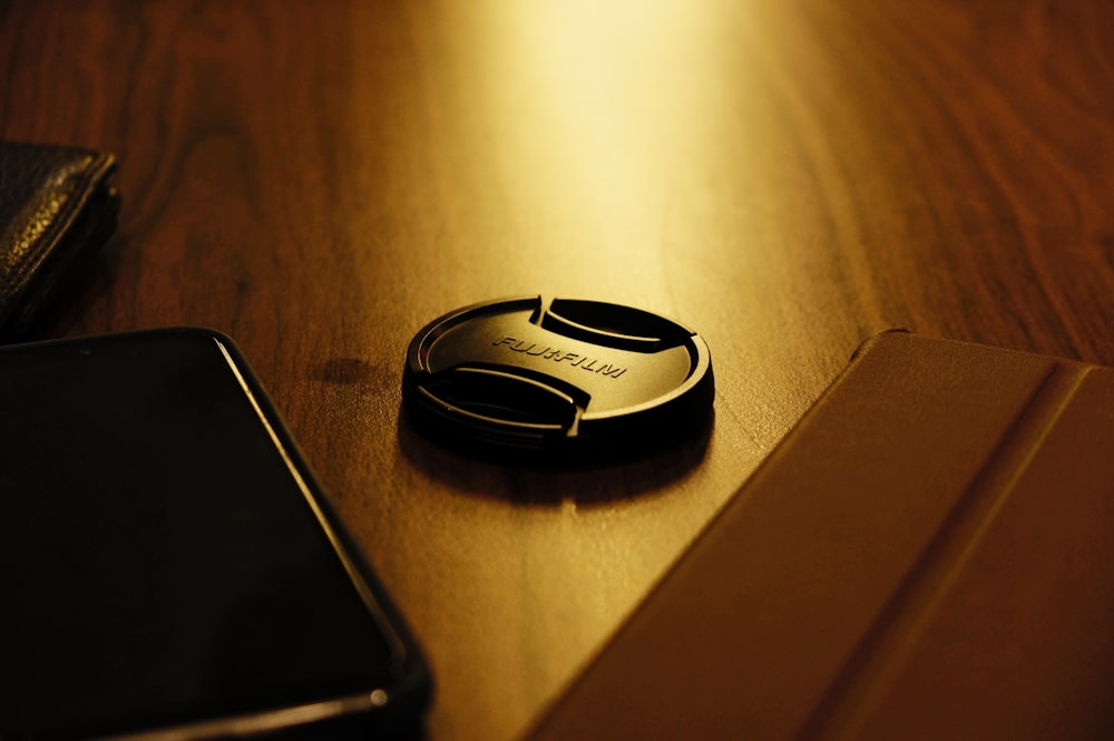 black and silver nikon camera lens cover on brown wooden table