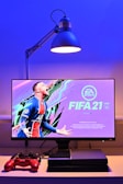 black flat screen tv turned on displaying man in blue and red jersey shirt