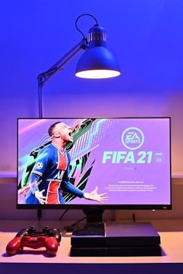 black flat screen tv turned on displaying man in blue and red jersey shirt