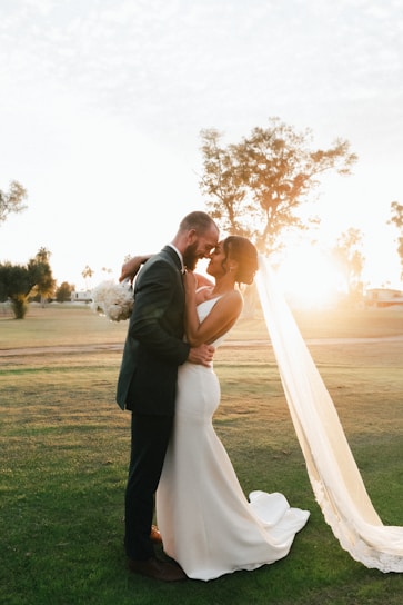 A softly lit, elegant bride and groom sharing a quiet moment framed by golden hour light and minimalist decor.