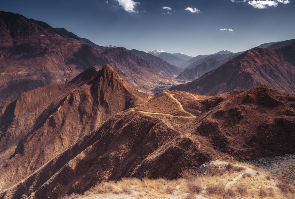 brown and green mountains under blue sky during daytime