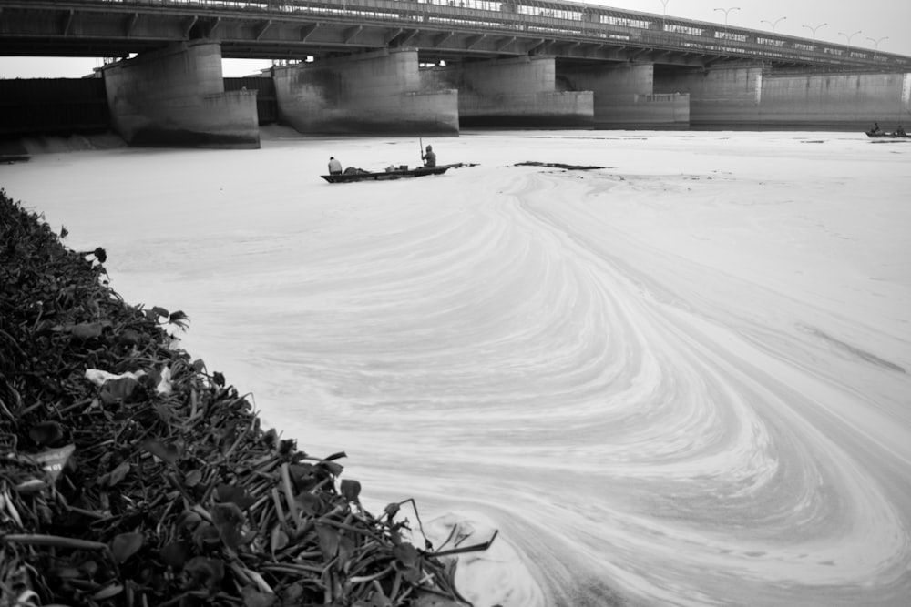 grayscale photo of bridge over river