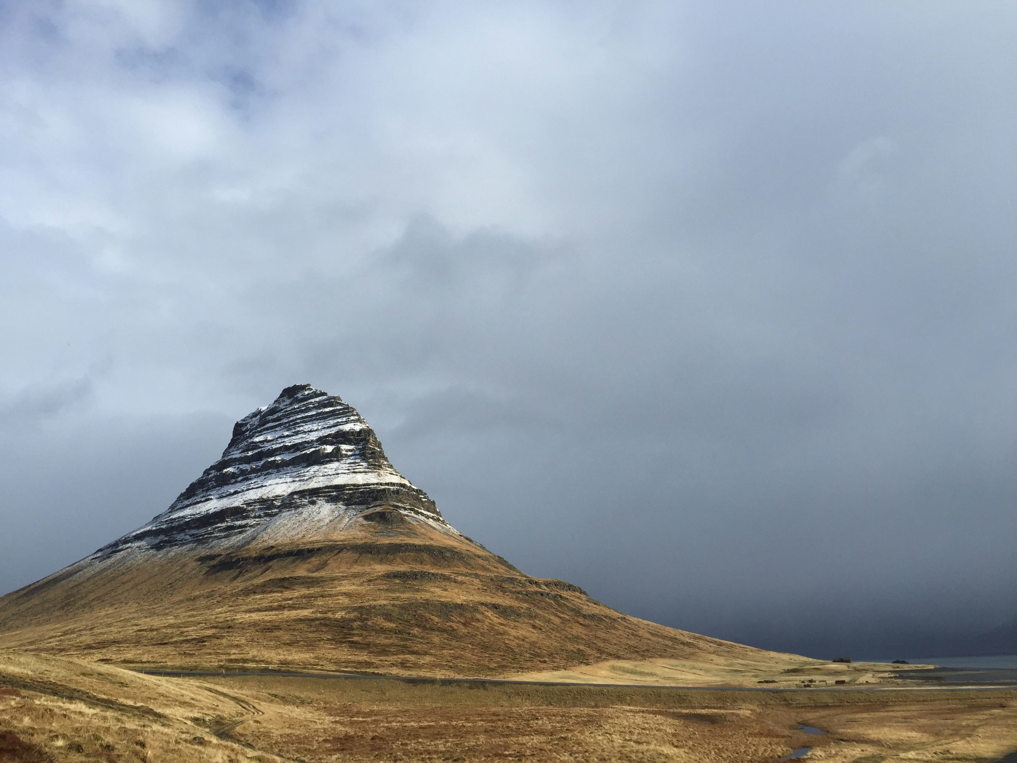 brown and green mountain under white clouds