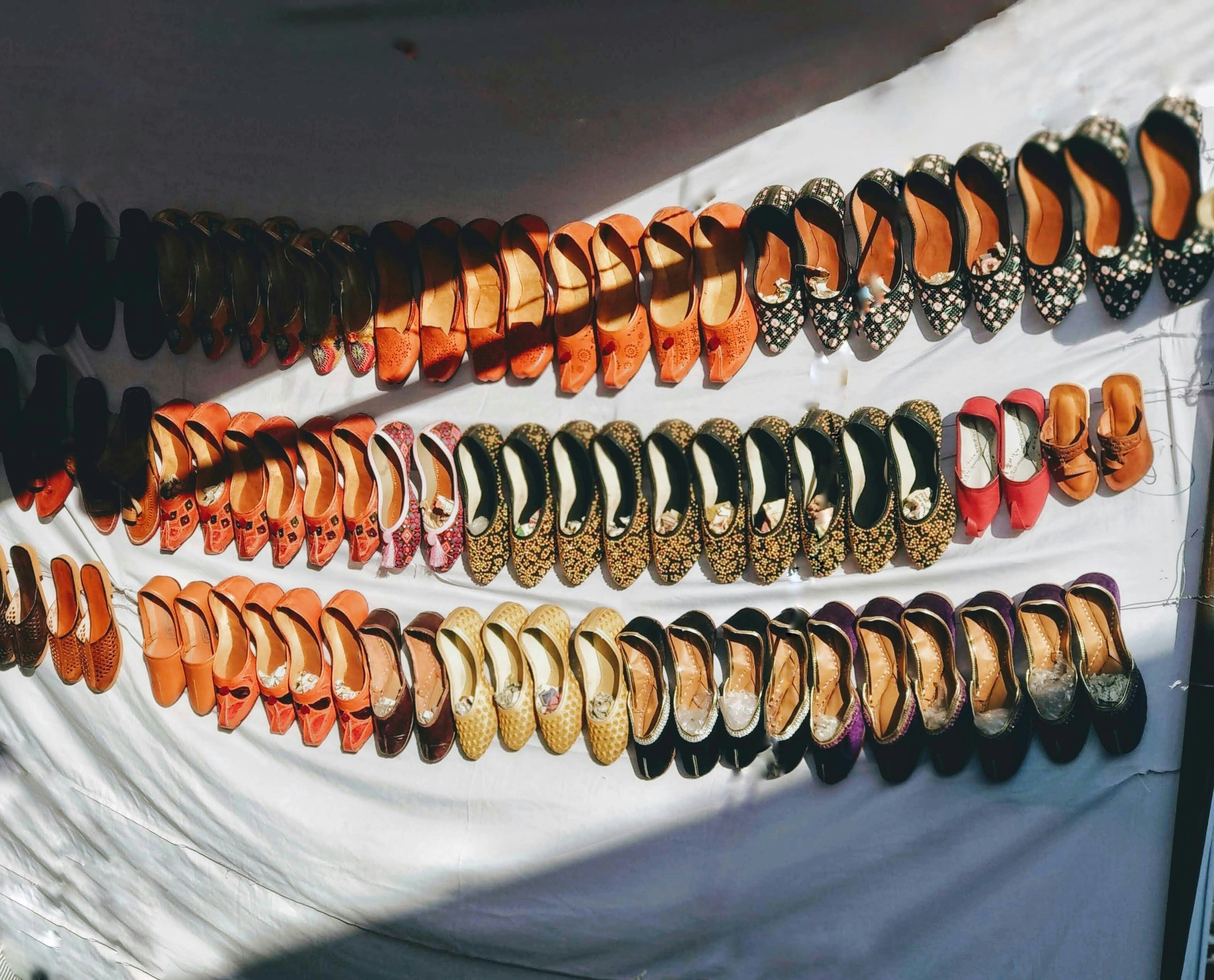 gold and silver bracelet on white textile