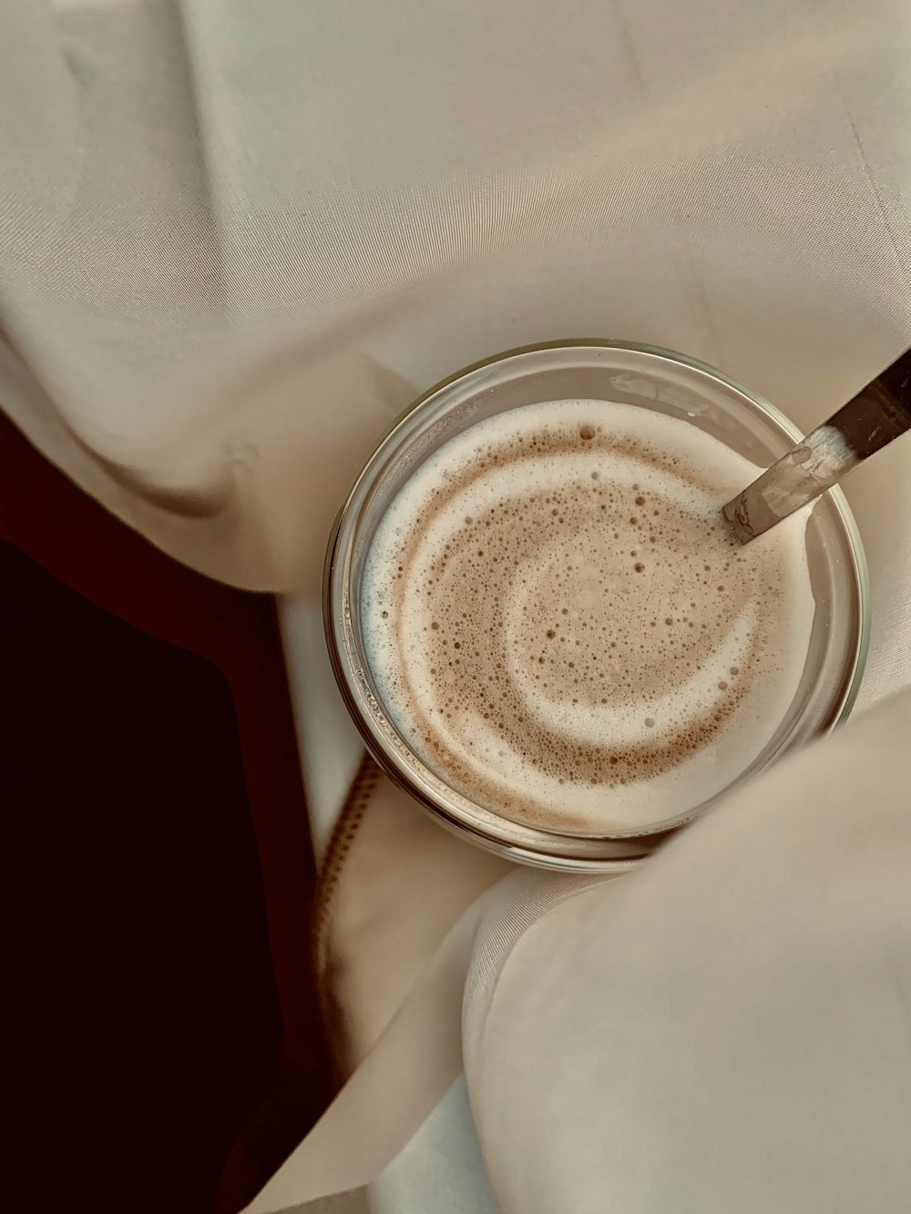 white ceramic mug with brown liquid