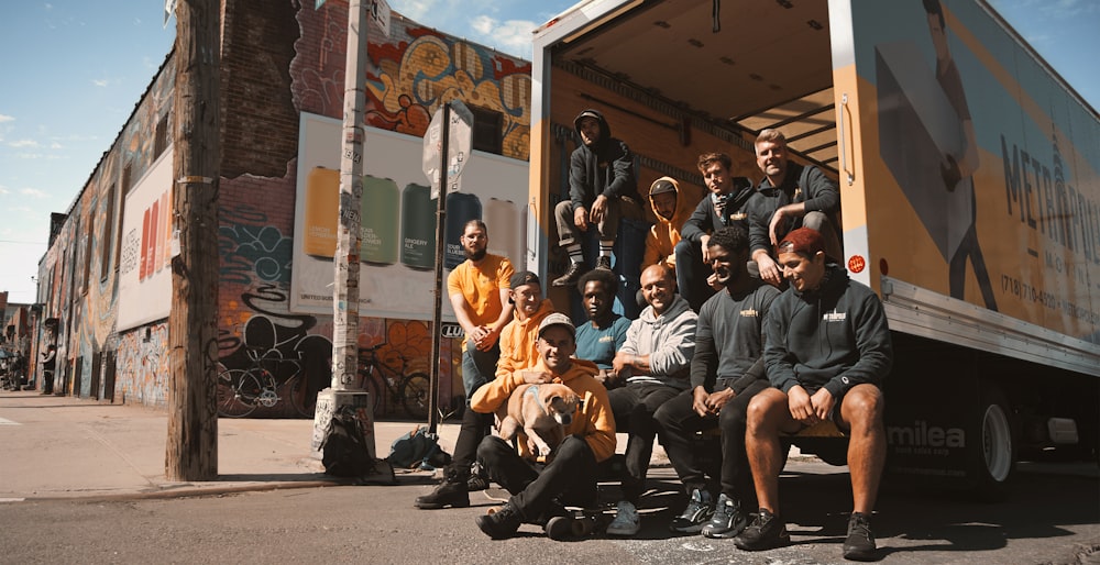 group of people sitting on black bench