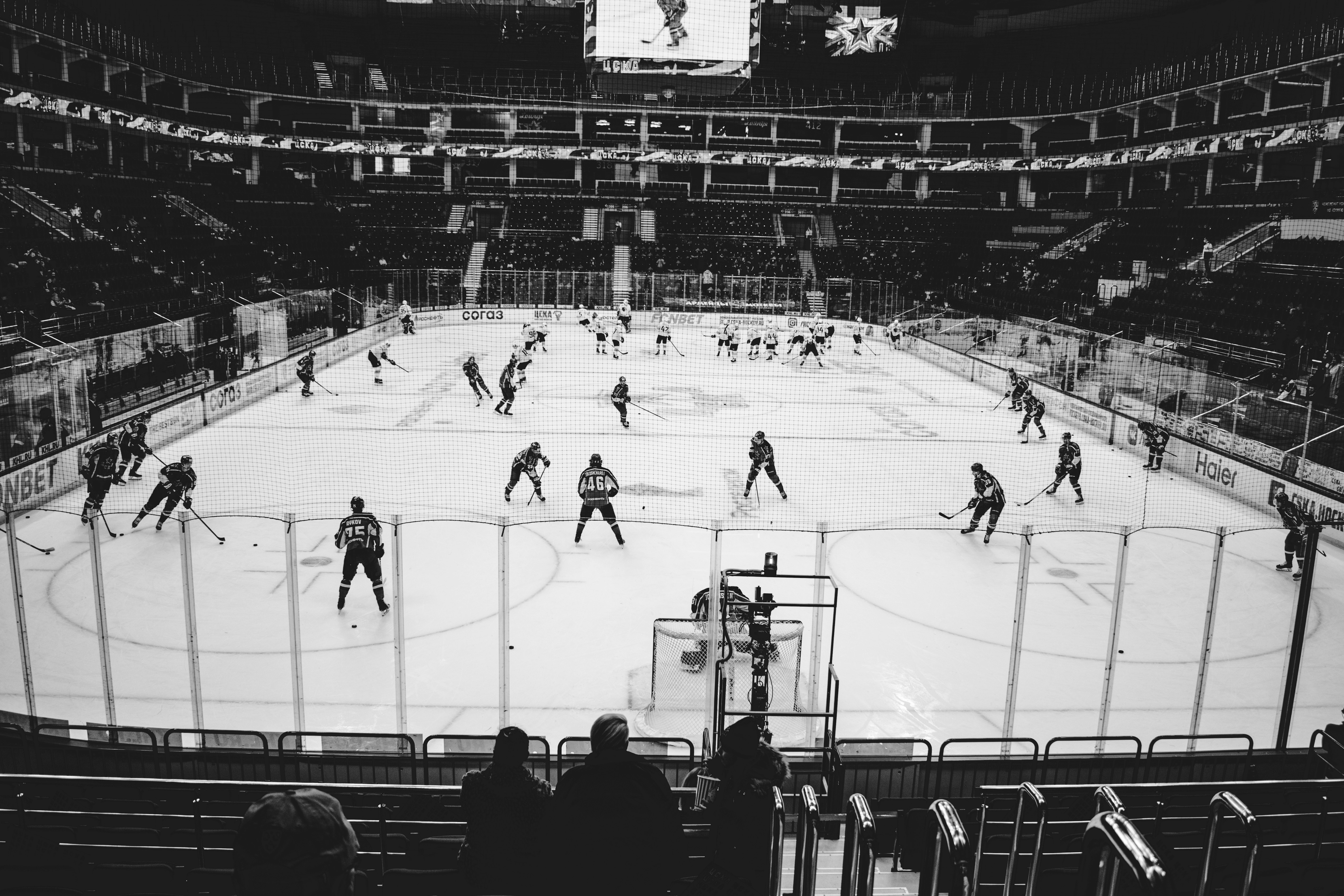 people playing ice hockey on ice field