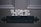 The word 'HOME' is painted in a decorative font on a dark wooden door above a black metal mail slot.