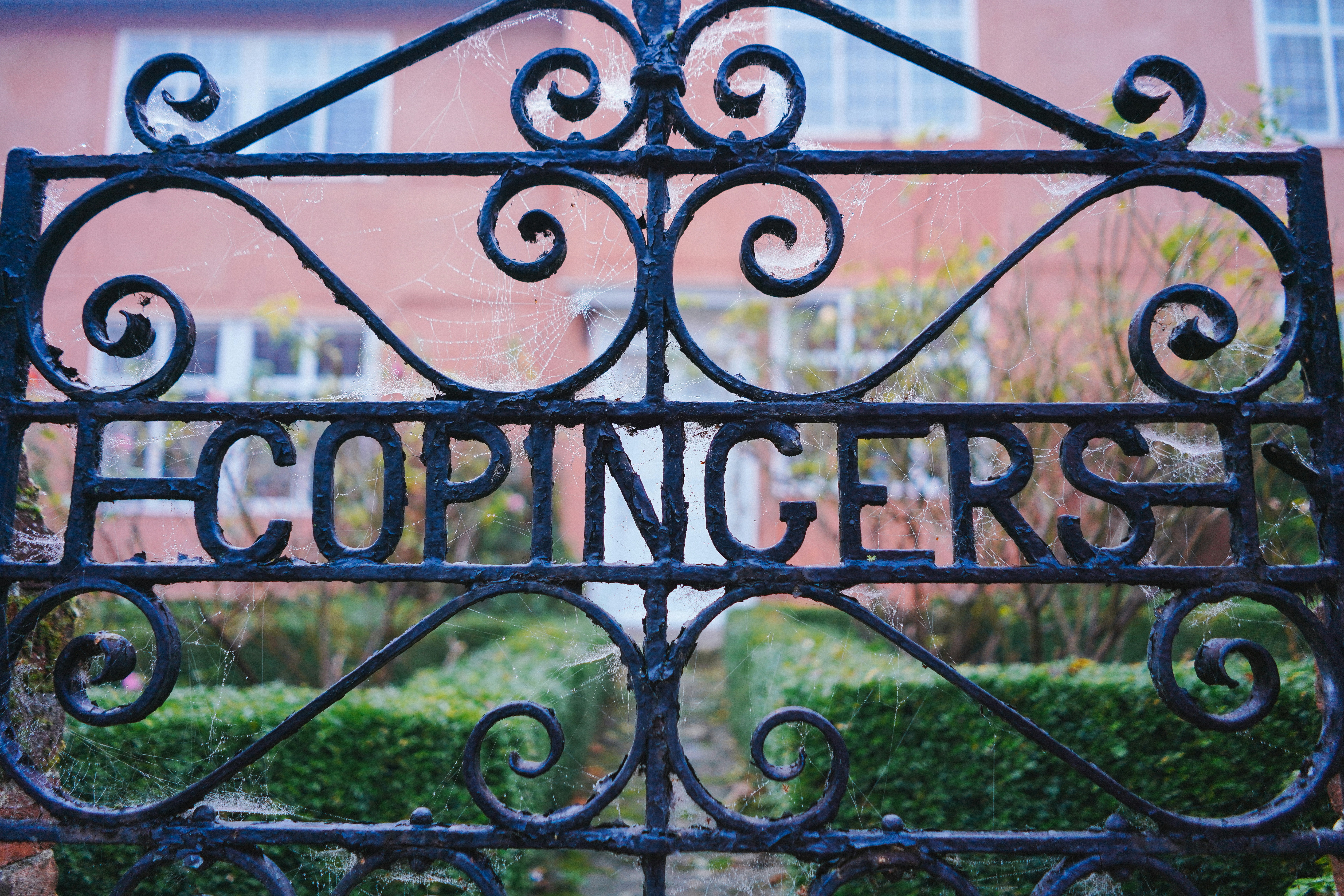 black metal fence with welcome to the beach signage