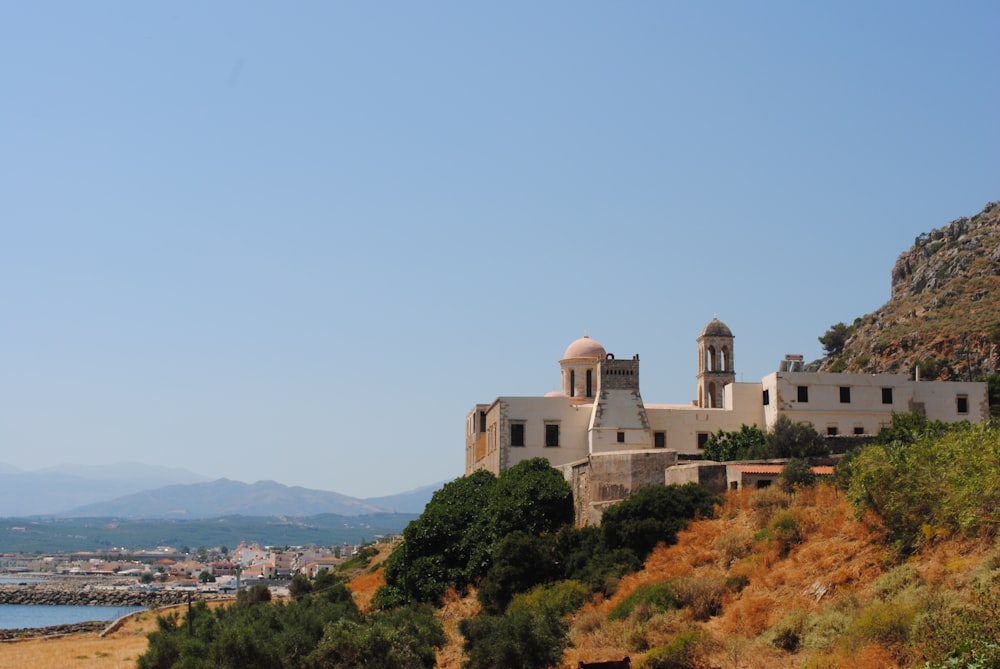 white concrete building on top of hill during daytime