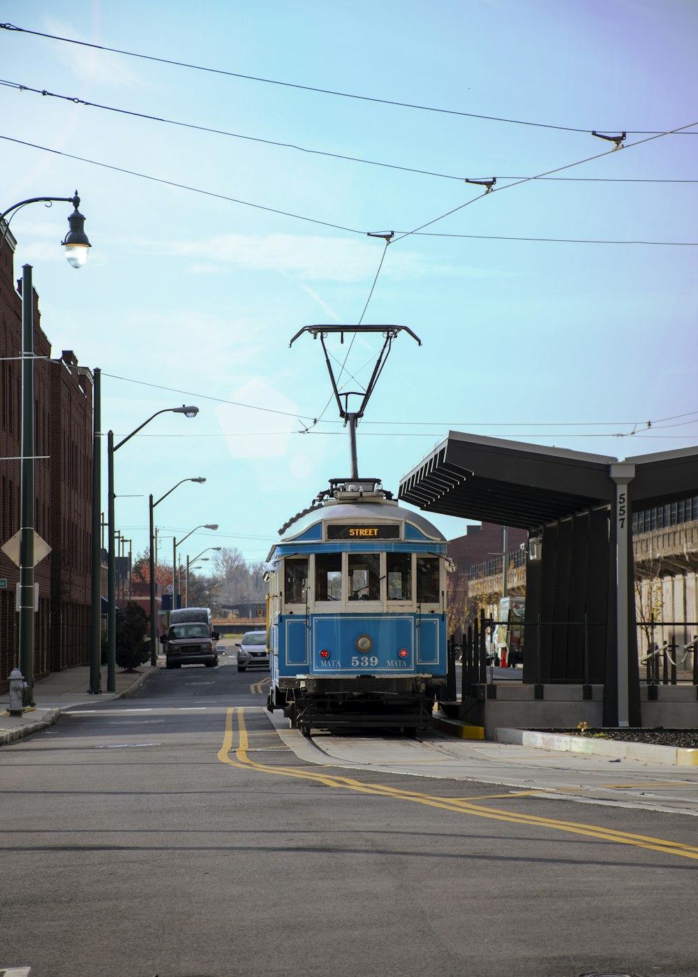 blue and yellow tram on road during daytime