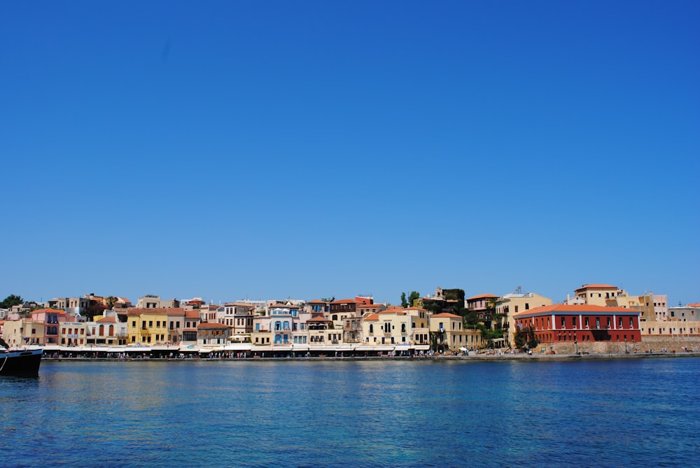 white and brown concrete buildings beside body of water during daytime